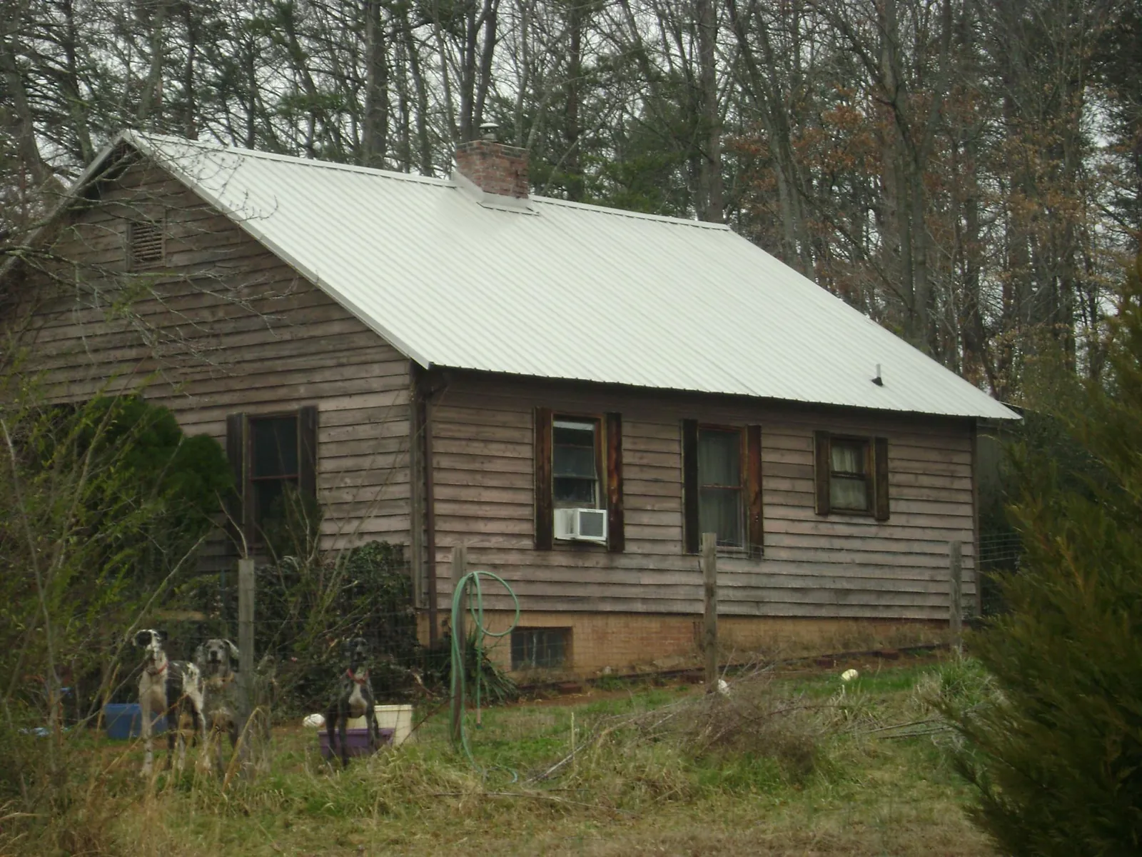 White metal roof on an old wood sided farmhouse, from a Metal Roof Installation job in Ridgefield